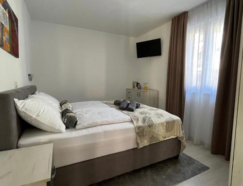 a bedroom with a bed and a television in it at Seafront 2-bedroom apartment Nika - Rabac in Rabac