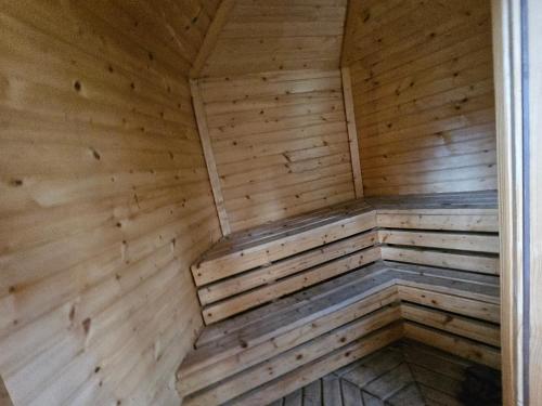 an empty sauna with wooden walls and ceilings at Leśny Zakątek Lipinki Bory Tucholskie - sauna in Lipinki