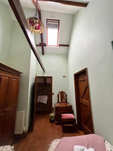 an attic room with a bed and a window at Cwmgwn Farm in Llandovery