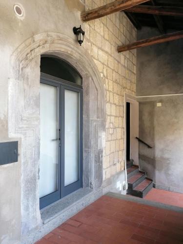 a door in a building with a brick wall at Casa del Palazzo del Marchese in Tarquinia