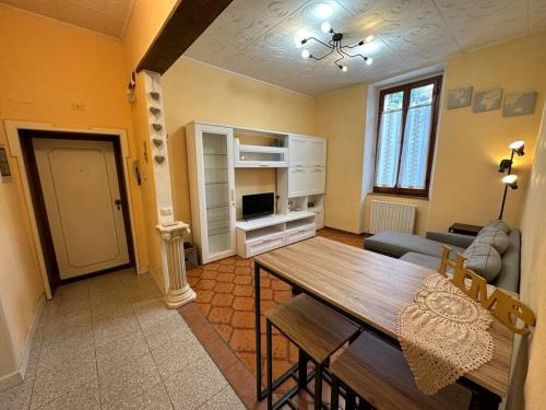 a living room with a dining room table and a couch at Dimitri's House! view of the Cathedral in Castelnuovo di Garfagnana