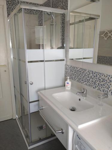a bathroom with a sink and a shower at "Casa Lungomare" Stintino paese in Stintino