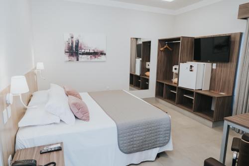 Postel nebo postele na pokoji v ubytování Portal Hotel Mogi Mirim