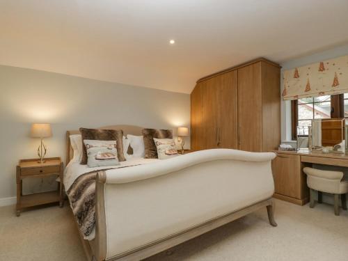 a bedroom with a large bed with a bath tub at Sundowner Cottage in Axminster