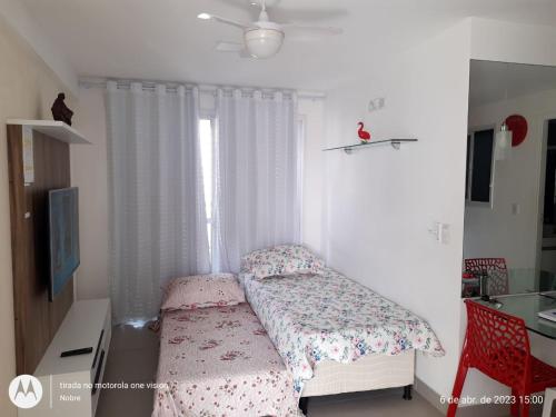 a small bedroom with a bed and a window at Apartamento 2 quartos May Way Meireles uma quadra da Beira-mar in Fortaleza