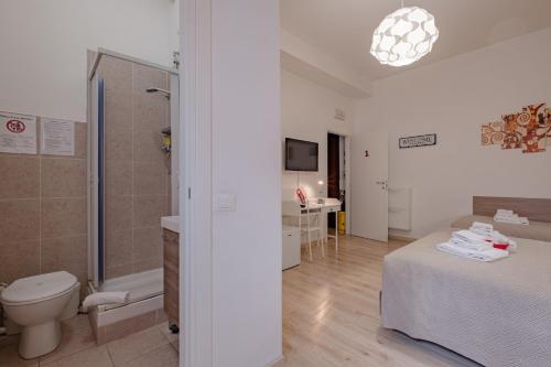 a bathroom with a bed and a shower and a toilet at Damiani & Sister Guesthouse in Rome