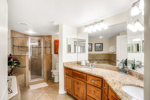 a bathroom with two sinks and a shower at Oceanwalk 17-406 in New Smyrna Beach