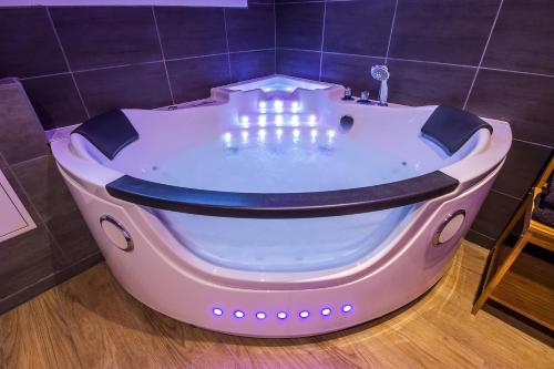 a bath tub with lights in a bathroom at Escapade en Bord de mer avec Sauna et Spa Privés in Binic-Etables-sur-Mer