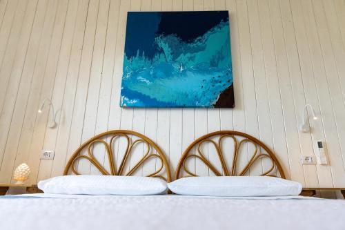 a bedroom with two beds and a painting on the wall at L'Aurora Scala Dei Turchi in Realmonte