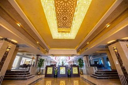 a large lobby with a large chandelier hanging from the ceiling at كازابلانكا بيتش in Hurghada