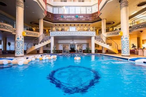 a large swimming pool in a building with stairs at كازابلانكا بيتش in Hurghada