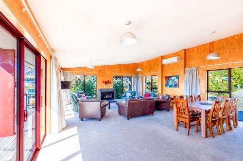 a living room with a table and chairs at Castle Hall - Lake Tekapo in Lake Tekapo