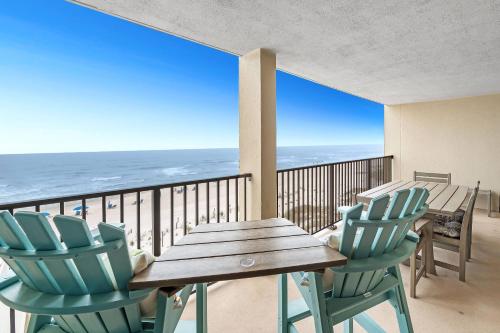 a table and chairs on a balcony with the ocean at Wind Drift 408SW in Perdido Key