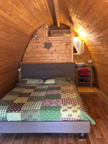 a bed in a room with a wooden ceiling at Igloo Mobil Home in Soiano del Lago