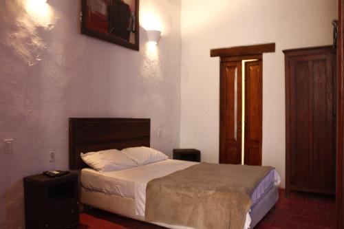 a bedroom with a bed in a room at Casa Gaitana - Alma Hotels in Santa Marta