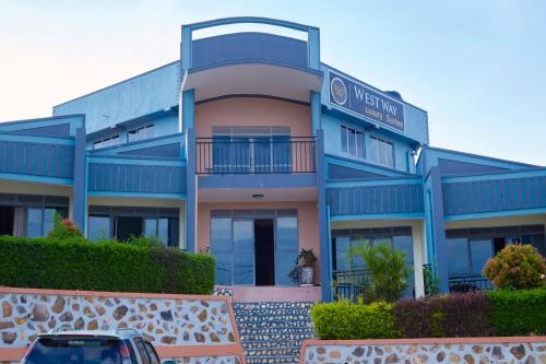 a building with a car parked in front of it at WestWay Luxury Suites in Mbarara