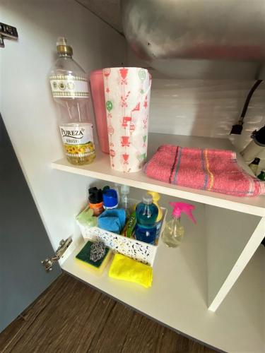 a white closet with a bottle of water and towels at Chalet Premium en Villa Privada "Casa Bonita" in San Rafael