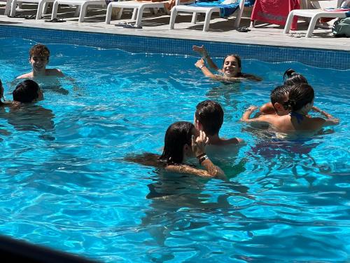 a group of people swimming in a swimming pool at Hotel Ardea in Riccione