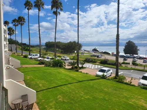 a view from the balcony of a house with palm trees at 13 at Santos in Mossel Bay