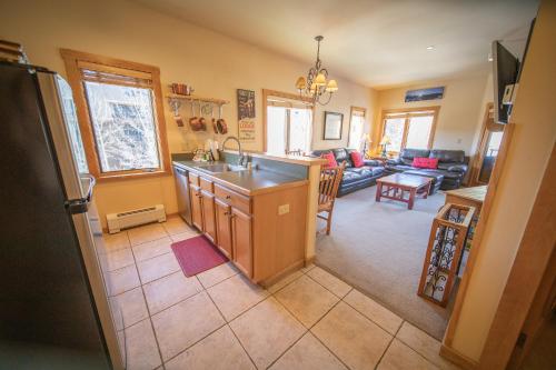a kitchen and living room with a sink and a counter at Arapahoe Lodge 8120 in Keystone