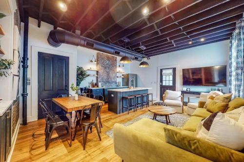 a living room with a couch and a table at Luxury 8 Bed/4 Ba NuLu Home Private yard/parking in Louisville