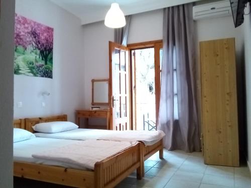 a bedroom with two beds and a window at Studios Thomas in Limenaria