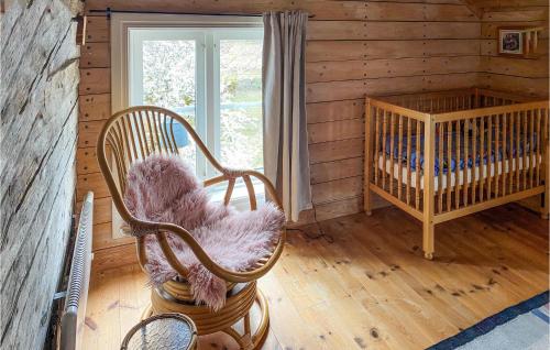 Zimmer mit Kinderbett und Stühlen in einer Hütte in der Unterkunft 4 Bedroom Lovely Home In Lammhult in Lammhult