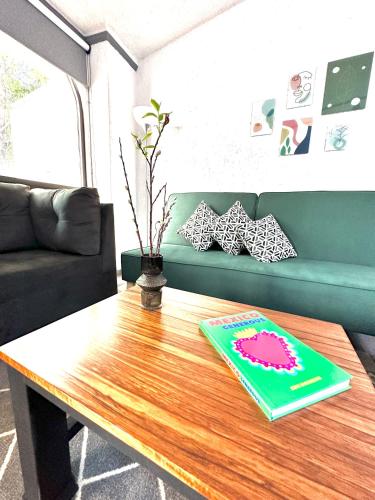 a coffee table in a living room with a couch at Departamento tipo LOFT cerca de hospital Angeles in Mexico City