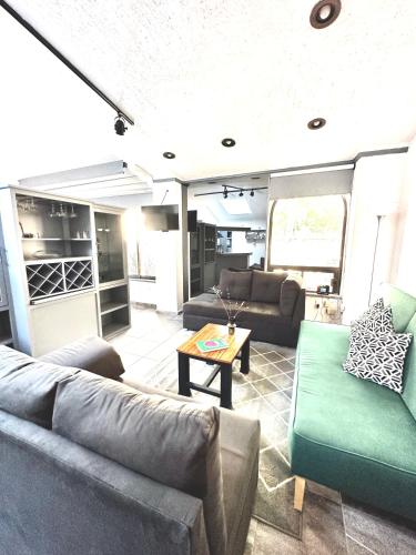 a living room with couches and a table at Departamento tipo LOFT cerca de hospital Angeles in Mexico City