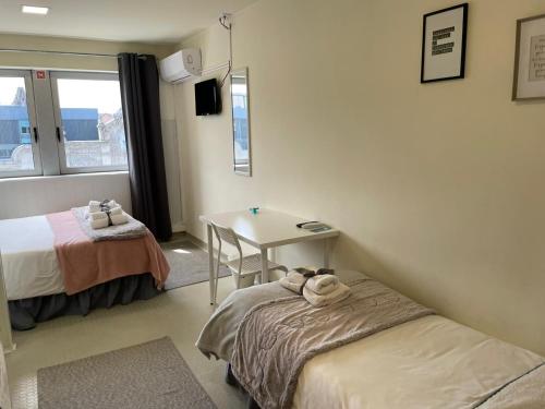 Ένα ή περισσότερα κρεβάτια σε δωμάτιο στο Liber Guest House