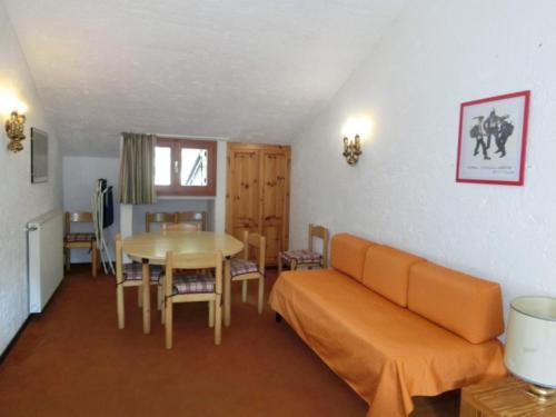 a living room with a couch and a table at Alberti - Condominio La Zangola in Madonna di Campiglio