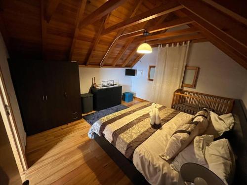 a person laying on a bed in a bedroom at Waves Song - Cottage in Porto Moniz