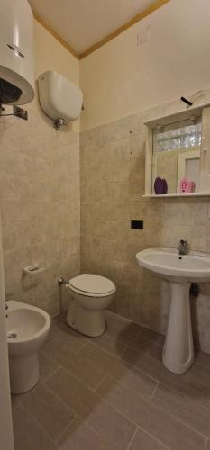 a bathroom with a toilet and a sink at Casa Arancio in Tarquinia