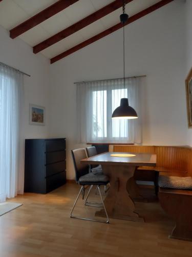a dining room with a table and chairs at Casa Petra in Magadino