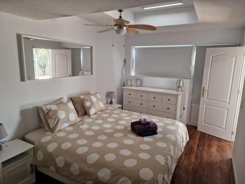 a bedroom with a bed and a ceiling fan at Casa Playa Chica Lanzarote in Puerto del Carmen