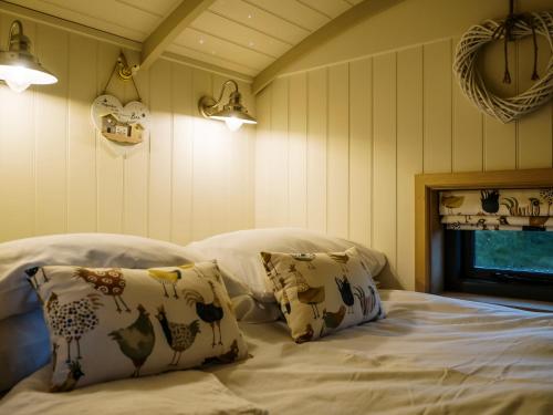 a bedroom with two pillows on a bed at Lillie's Shepherds Hut in Nottingham