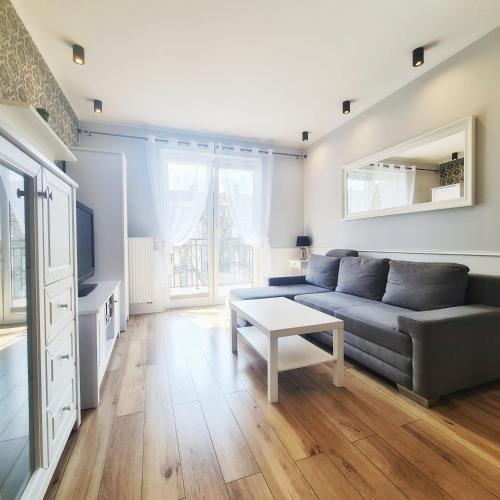 a living room with a couch and a table at Apartament Gdańska in Bydgoszcz