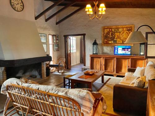a living room with a couch and a fireplace at Casa en Haras Bettina in Mercedes
