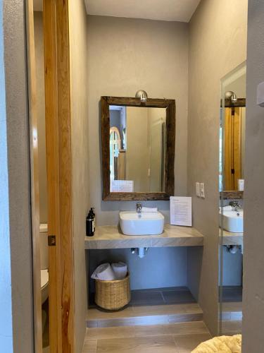 a bathroom with a sink and a mirror at Hotel Casa Caro in Bernal