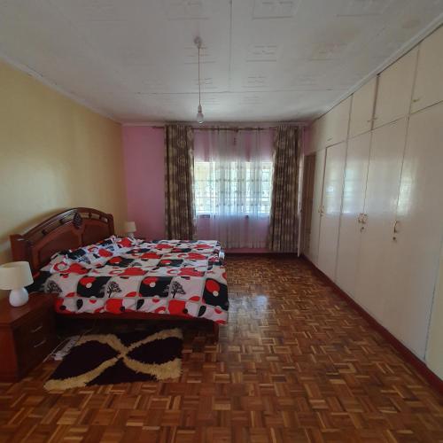 a bedroom with a bed with a cow blanket at Château Lake-ish in Nakuru