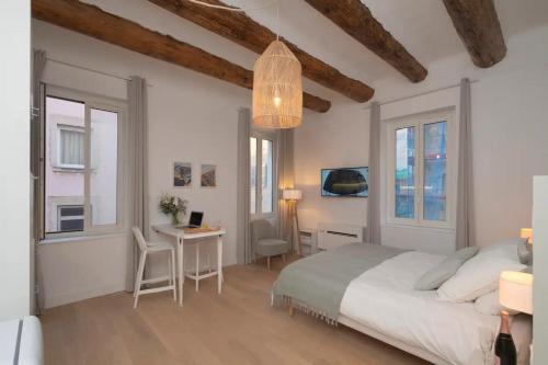 a bedroom with a bed and a table and chairs at Design Suites Vieux Port in Marseille