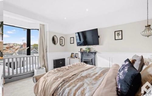 Schlafzimmer mit einem Bett und einem Flachbild-TV in der Unterkunft Victorian Town House central Cheltenham in Cheltenham