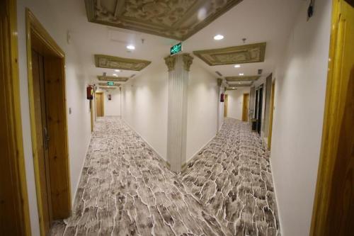 an empty corridor in a building with a bed at السهم الذهبي للشقق المخدومة in Taif