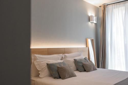 Postel nebo postele na pokoji v ubytování Archè Design Rooms and Suites