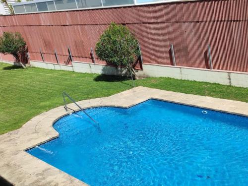 a small blue swimming pool in a yard at Apartamentos Ruta da Auga in Ribadumia