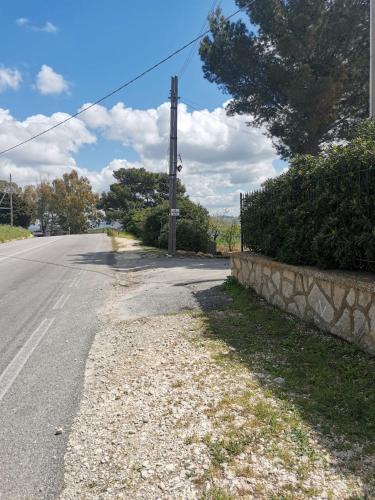 an empty road with a telephone pole on the side at Trapani Emotions apartment in Valderice