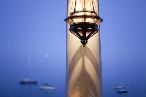 a light pole with a clock on top of it at Hotel Cincotta in Panarea