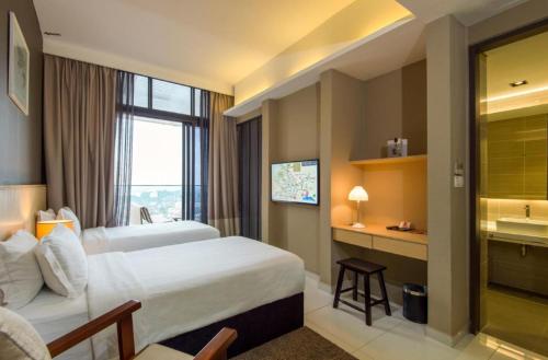 a hotel room with a bed and a window at The Honeymoon Haven - 99 Residences in Melaka