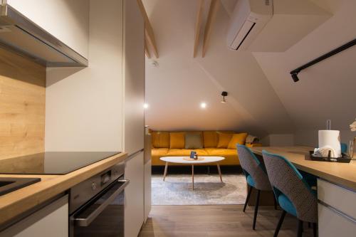 a kitchen and living room with a table and chairs at Mayisa Apartments in Sarajevo