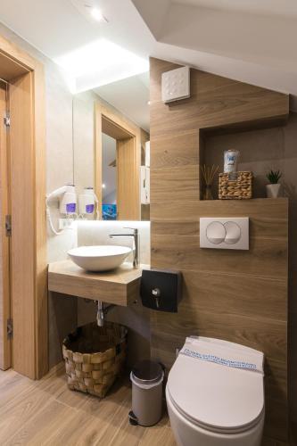 a bathroom with a toilet and a sink at Mayisa Apartments in Sarajevo
